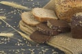 Sliced and whole Ã¢â¬â¹Ã¢â¬â¹rye bread and ears of rye on wooden rustic background